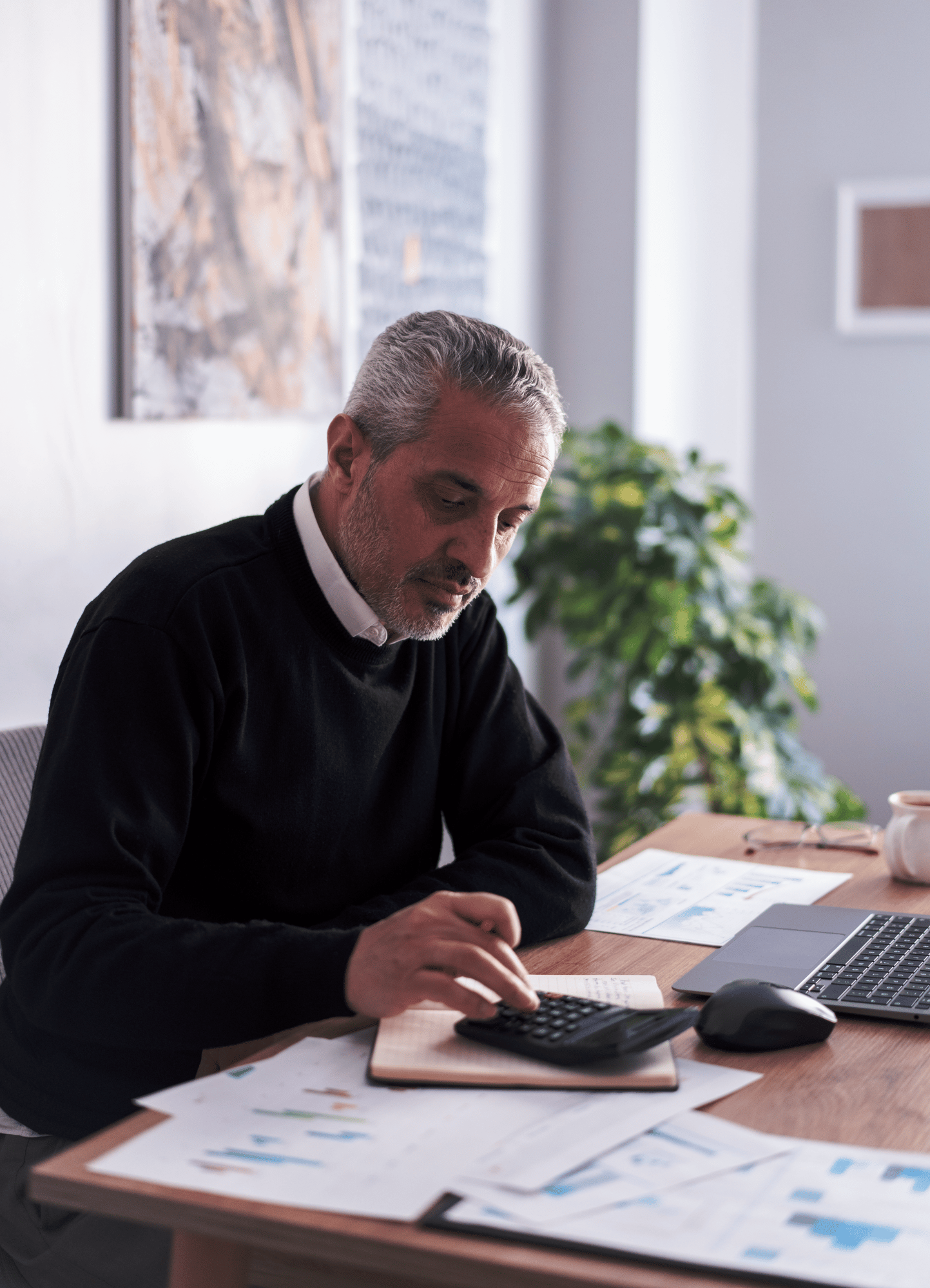 southern european man doing work on calculator inquisitive-1 southern european man doing work on calculator inquisitive-1